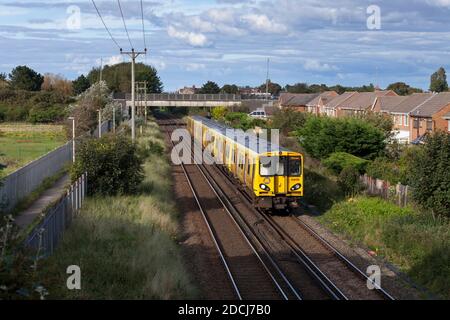 Merseyrail Electrics class 508 + 507  third rail electric trains 508128 + 507007 passing Ainsdale on the Merseyrail Northern line Stock Photo