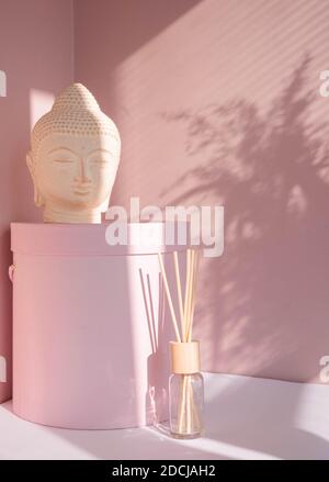 White Buddha bust on pastel pink background Stock Photo