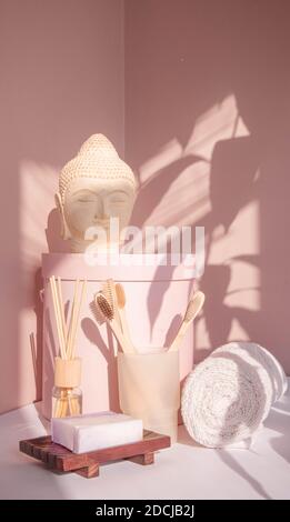 White Buddha bust on pastel pink background Stock Photo