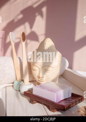 White Buddha bust on pastel pink background Stock Photo