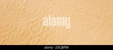 Top view on a pattern of clean beach sea sand. Panoramic background with texture. Stock Photo