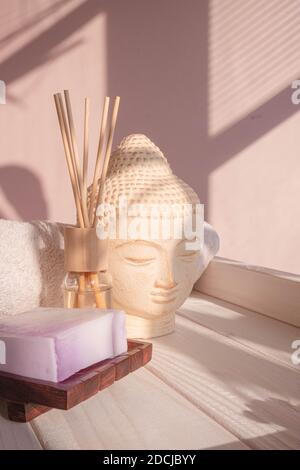 White Buddha bust on pastel pink background Stock Photo