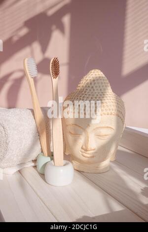 White Buddha bust on pastel pink background Stock Photo