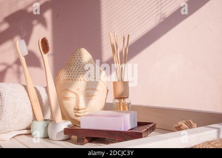 White Buddha bust on pastel pink background Stock Photo