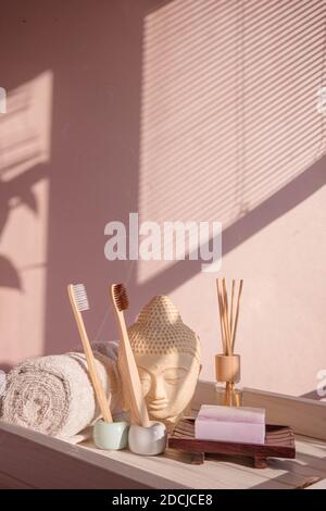 White Buddha bust on pastel pink background Stock Photo