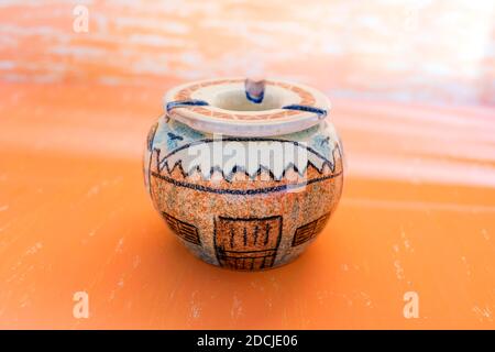 Cairo ,10.2020  colored handmade pottery Ashtray decorated  on gradian yellow abstract background. Stock Photo