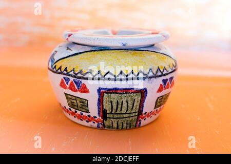Cairo ,10.2020  colored handmade pottery Ashtray decorated  on gradian yellow abstract background. Stock Photo