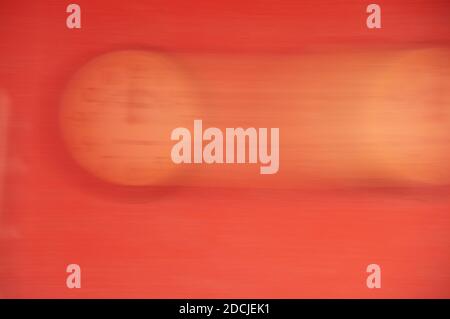 The clock is out of focus on a red background. Running time. Stock Photo