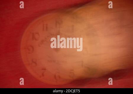 The clock is out of focus on a red background. Running time. Stock Photo