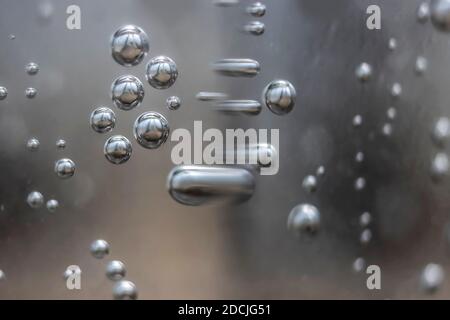 Macro Photo of Metal Balls Floating and Transorming in Space Stock Photo