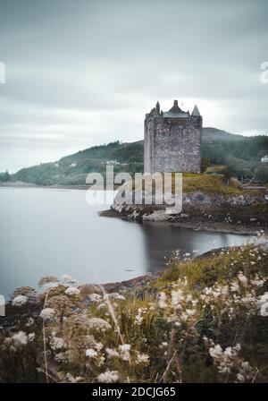 A beautiful shot of the Castle Stalker, a four-story tower house on a tidal islet on Loch Laich Stock Photo