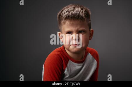 Drama boy showing with his face I Dont Like You to his parents isolated on grey background. Fake child emotions. Human emotions, facial expression Stock Photo