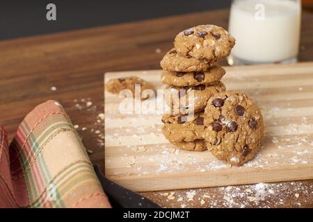 Closeup shot of freshly baked chocolate chip cookies on a wooden board Stock Photo