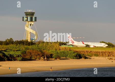 Virgin Australia Boeing 737 taxiing at Sydney Airport close to the Plane Spotting Beach in Mascot, Australia. Air Traffic Control tower behind. Stock Photo