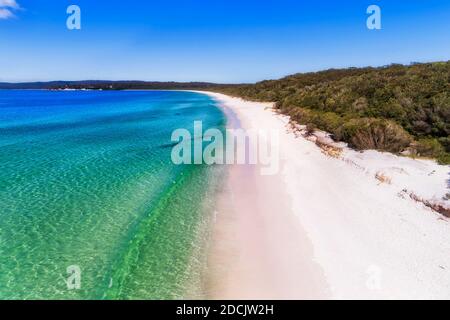 Smooth wave rolling on white sand dune of Hyams beach in Jervis bay - elevated aerial view. Stock Photo