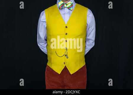 Portrait of Man in Bright Yellow Waistcoat and Colourful Bow Tie Stock Photo