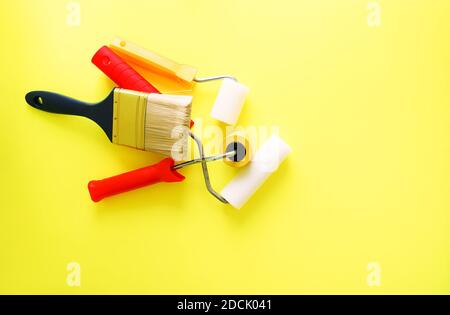 Repair tools on bright background. Foam rollers and brush for wall painting. Stock Photo