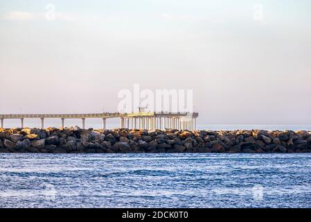 Coastal view with the Mission Bay Channel Jetty and the Ocean Beach Pier. San Diego, California, USA. Stock Photo