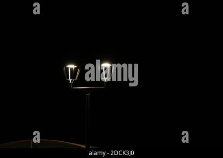 View glowing street lantern on a dark black night background Stock Photo