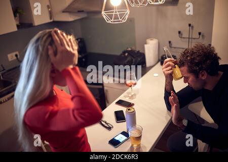 worried female trying to talk with drunk male. alcohol issue concept Stock Photo