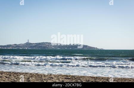 Views of Coquimbo city and the famous Cruz del Tercer Milenio from empty beach in La Serena, Chile Stock Photo