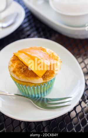 A cupcake with cream cheese frosting at a local cafe in Leyte, Philippines Stock Photo