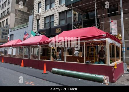 Manhattan, New York, USA. 21st Nov, 2020. Construction continues on outdoor dining patios on 36th street as the city prepares for a possible second shutdown during The Covid-19 pandemic in Manhattan, New York. Mandatory credit: Kostas Lymperopoulos/CSM/Alamy Live News Stock Photo