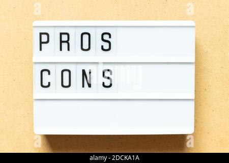 Lightbox with word  pros cons on wood background Stock Photo