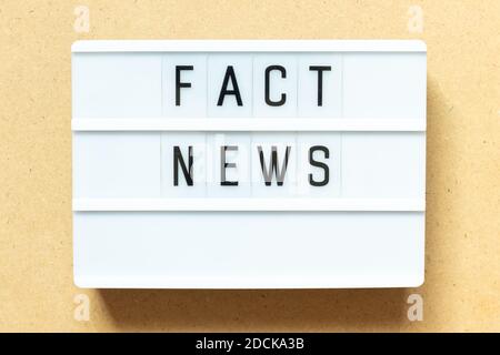 Lightbox with word fact news on wood background Stock Photo