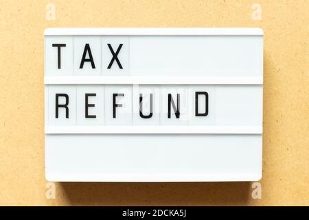 Lightbox with word tax refund on wood background Stock Photo
