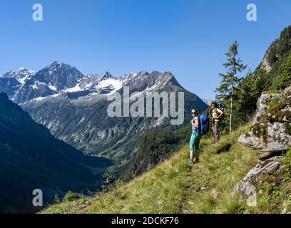 Hikers look at mountains, Zamser Eck, Kleiner Hochsteller, Kaelberlahnerspitze and Hochsteller, Zillertaler Alps, Zillertal, Tyrol, Austria Stock Photo