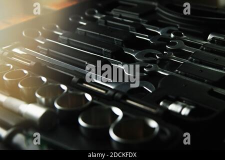Box with set of tools for car repair, close-up, low key with lens glare Stock Photo