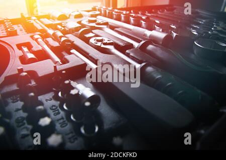 Sockets, tools, wrenches, spanners and bits in a chrome vanadium socket set in black plastic box. lens flare Stock Photo
