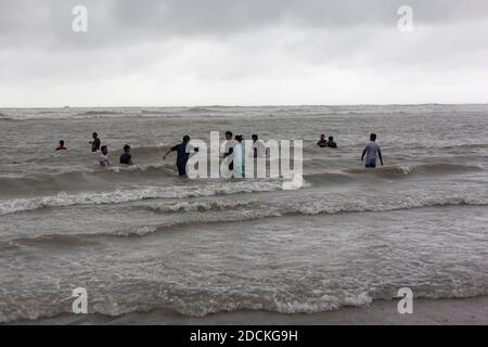 Bathers on the beach from Cox's Bazaar to monsoon rain, the beach at the Bay of Bengal in southeastern Bangladesh is considered with a length of 150 Stock Photo