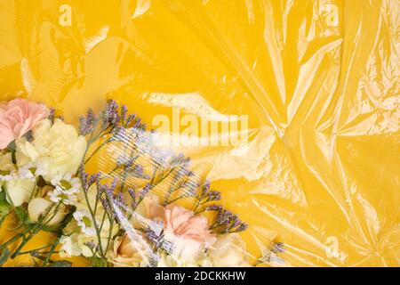 Flowers under a transparent film. Polyethylene Film Stock Photo