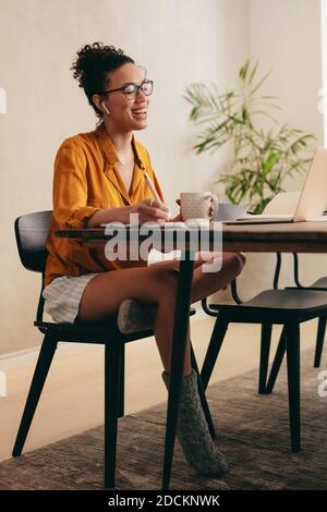 Woman having a video call meeting at home. businesswoman in meeting by video conference while working from home. Stock Photo