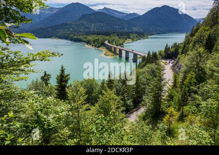 Lake Sylvenstein Panorama view from the steep slope of a nearby mountain, looking down on the highway bridge Upper Bavaria, Germany, Europe Stock Photo