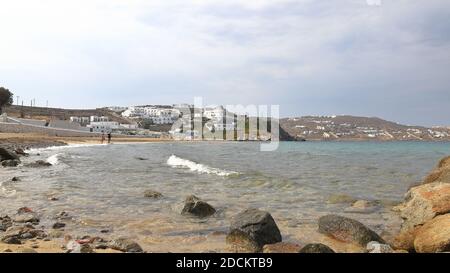 The view along Megali Ammos Beach on the Greek island of Mykonos.  This is the closest beach to the town of Mykonos. Stock Photo