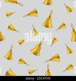 Seamless background on the theme of Christmas and New Year. Christmas background with yellow bells on a gray background. Printing on paper, fabric or Stock Photo