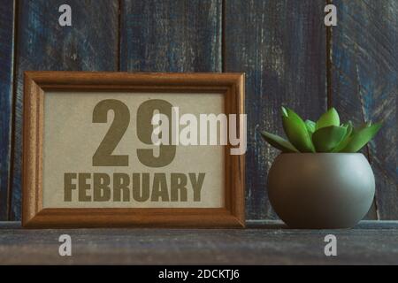 february 29th. Day 29 of month,  date in frame next to succulent on wooden background winter month, day of the year concept. Stock Photo