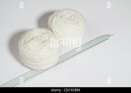 Balls of yarn for hand knitting with knitting needles on a light background Stock Photo