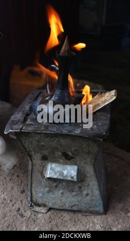 Traditional Ethiopian coffee pot brewing on open fire Stock Photo