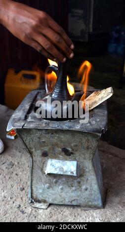 Traditional Ethiopian coffee pot brewing on open fire Stock Photo