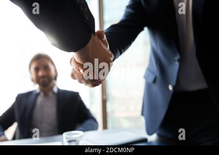 Close up of businessmen shake hands at meeting Stock Photo