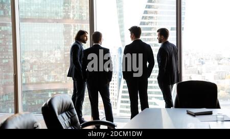 Back view of successful businessmen negotiate in office Stock Photo