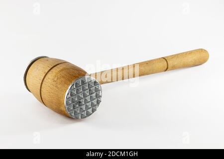 Old rustic wooden meat mallet hammer, isolated on white background. Stock Photo