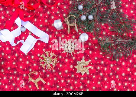 Creative Christmas DIY layout.Christmas decoration pattern with red background. Minimal flat lay concept space for text.Xmas composition.Tree branches Stock Photo