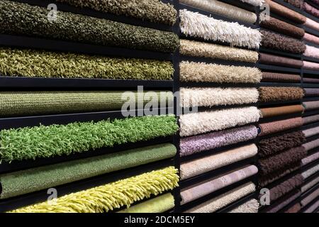 Samples of carpets of different colors on a stand in a store or production. Multi-colored carpet samples on the floor Stock Photo