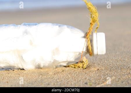 Spilled garbage on the beach of the big city. Empty used dirty plastic bottles. Dirty sea sandy shore the Black Sea. Environmental pollution. Ecologic Stock Photo