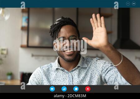 Young african ethnicity handsome bearded man making hello gesture. Stock Photo